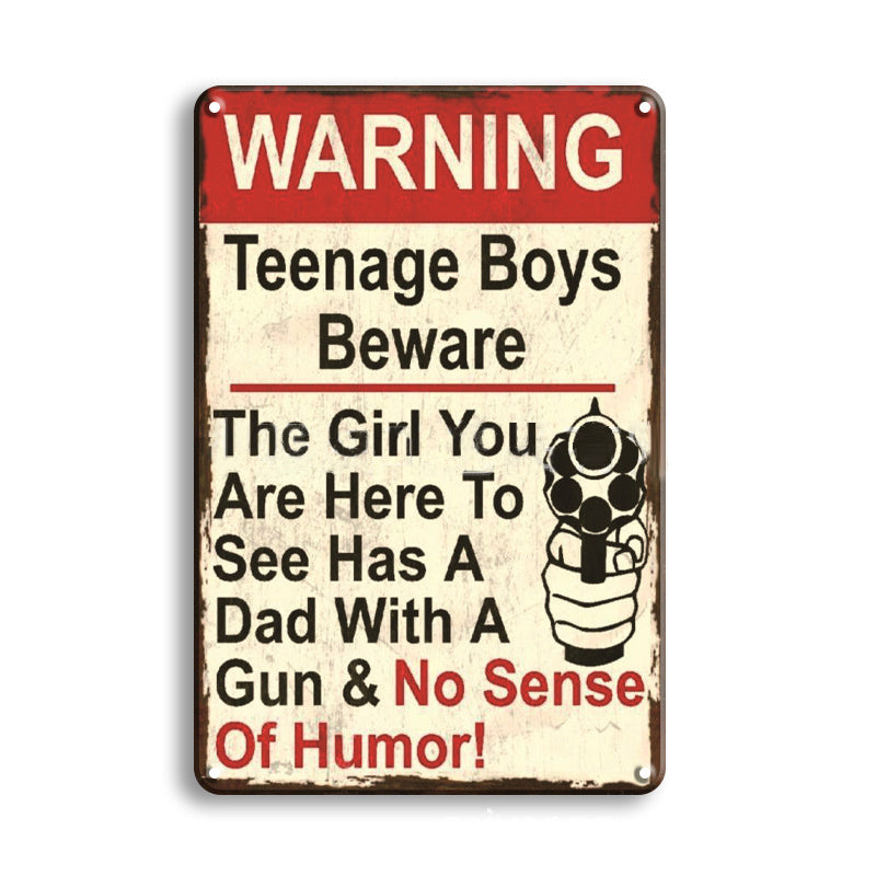 Metal sign with humorous warning text about teenage boys and a girl with a gun, on a white background.