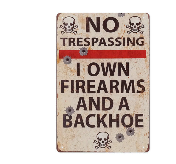 Vintage-style metal sign with 'No Trespassing' and 'I Own Firearms and a Backhoe' text on a white background.