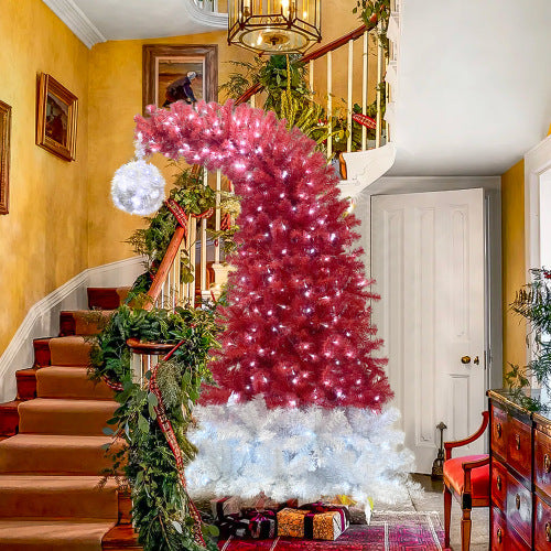 Decorative Christmas tree with red and white lights in a home setting.