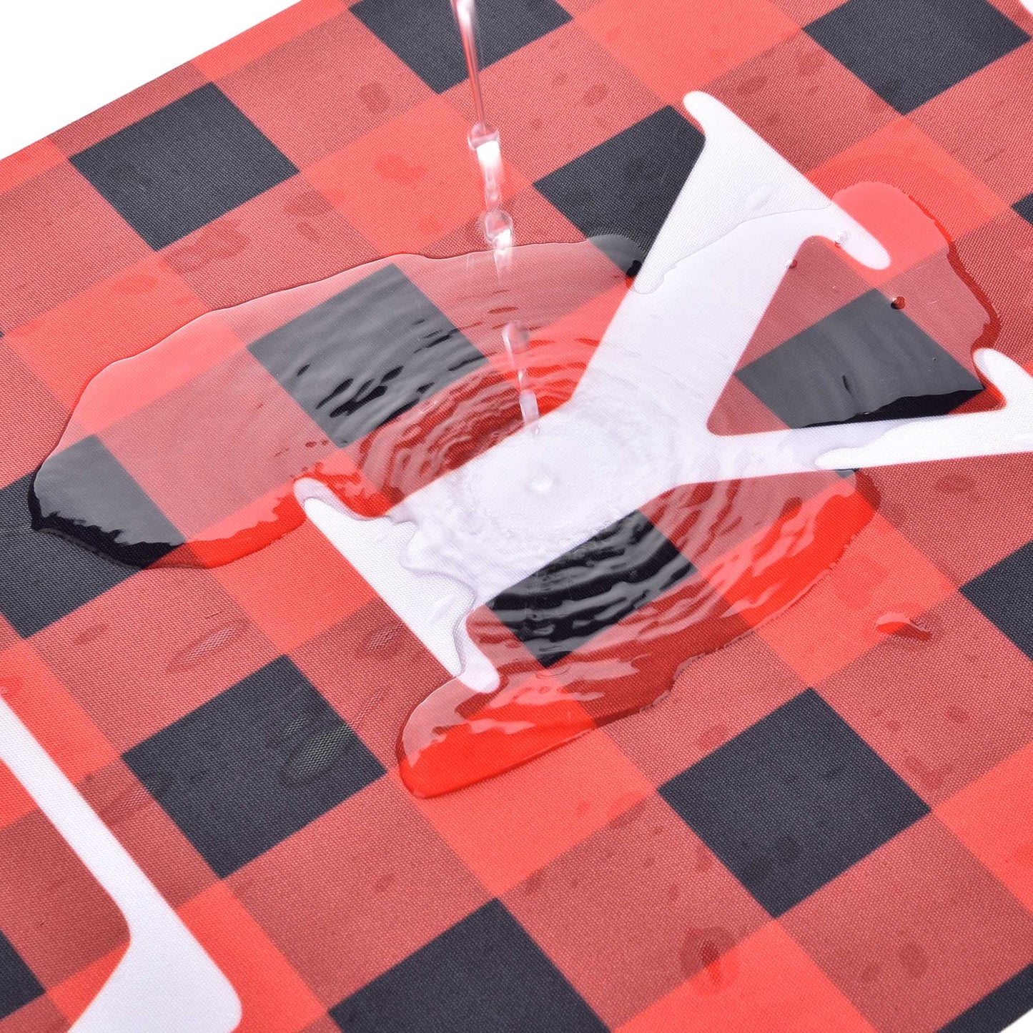 White plastic bag with red liquid on a red and black checkered surface