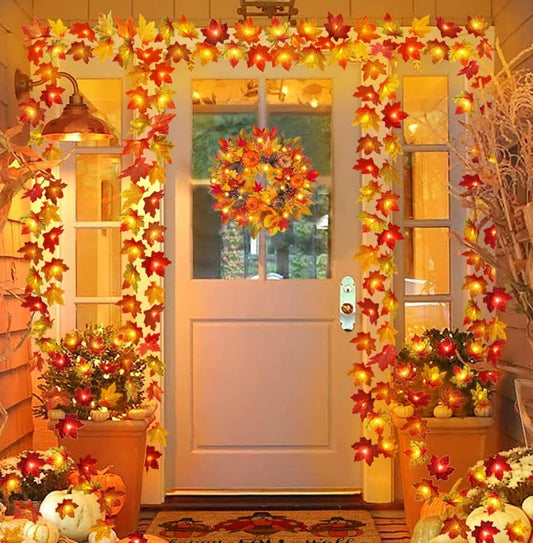 Decorative autumn wreath and garlands on a door with pumpkins and lights.