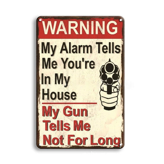 Metal sign with humorous text and graphic of a hand holding a gun, on a white background.