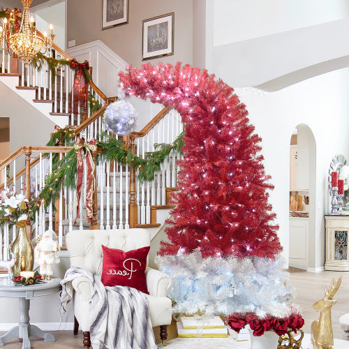 Decorative Christmas tree with red and white lights in a living room setting.